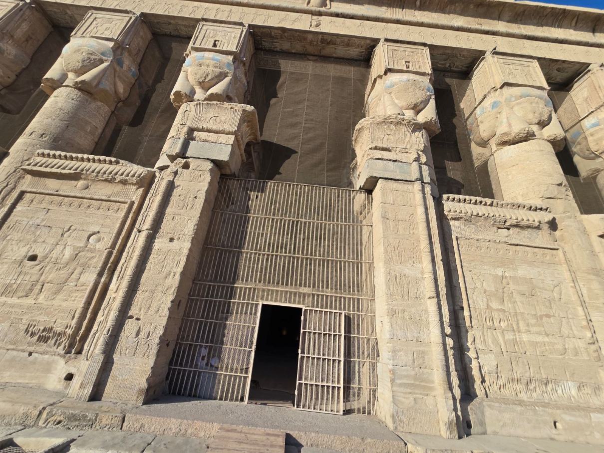 The carved facade and Hathor columns of an ancient Egyptian temple.